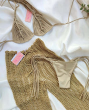 Load image into Gallery viewer, Gold crochet trousers and bikini set on soft fabric, showcasing luxurious beach cover-up styles.