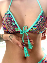 Load image into Gallery viewer, Close-up of made-to-order hand beaded bikini top with intricate patterns and vibrant colors, featuring removable pads and tassels.