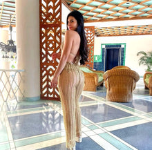 Load image into Gallery viewer, Gold crochet trousers cover-up showcasing luxury design and flattering fit in an elegant indoor setting.