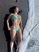 Charger l'image dans la galerie, Elegant turquoise hand-beaded bikini on a woman by the beach, showcasing expert craftsmanship and stylish design.