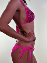 Load image into Gallery viewer, Model wearing the Catriona hand-beaded bikini in vibrant fuchsia, showcasing its stunning Czech bead detail.