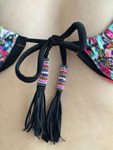Load image into Gallery viewer, Close-up of the hand-beaded tie detail on the back of a colorful Brazilian bikini.