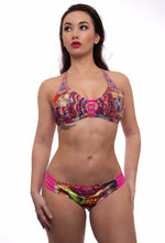 Load image into Gallery viewer, Model showcasing the Abundance bikini featuring vibrant patterns, handcrafted details, and a flattering fit, ideal for summer style.