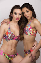 Load image into Gallery viewer, Two models showcasing the ๐ผ๐๐ช๐ฃ๐๐๐ฃ๐๐ Silky Bikini with vibrant, colorful patterns and a flattering fit.