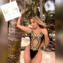 Load image into Gallery viewer, Katterine β Hand-beaded Trikini model posing by palm trees in a tropical beach setting, showcasing intricate details.