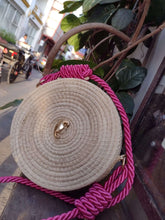 Load image into Gallery viewer, Handmade Iraca Palm Seahorse canteen bag with pink rope handle, showcasing traditional craftsmanship and elegant design.