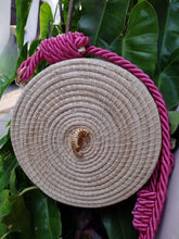 Load image into Gallery viewer, Handmade Iraca palm seahorse canteen bag with pink strap, showcasing intricate craftsmanship and natural materials.