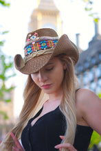 Load image into Gallery viewer, Stylish Scarlett Brown Hat on a woman, blending fashion and practicality in a scenic outdoor setting.