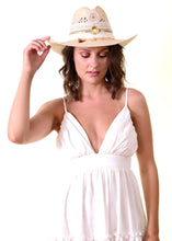 Charger l'image dans la galerie, Model showcasing the Handmade Iraca Palm Hat with a white dress, highlighting its elegance and craftsmanship.
