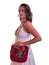 Load image into Gallery viewer, Model showcasing the handmade Tala leather handbag with vibrant hand-painted details and crossbody design.