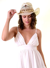 Load image into Gallery viewer, Woman wearing a Handmade Iraca Palm Hat, showcasing unique craftsmanship and elegance in a white dress.
