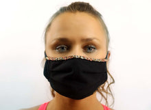 Load image into Gallery viewer, Adara hand-beaded face mask in black worn by a model, showcasing its elegance and artisanal craftsmanship.