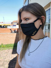 Load image into Gallery viewer, Adara hand-beaded face mask worn by a young woman, featuring elegant design and three layers of breathable cotton.