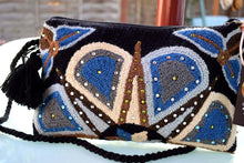 Load image into Gallery viewer, Embellished Wayuu terry cloth clutch featuring vibrant colors and intricate handmade designs.