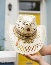 Load image into Gallery viewer, Handmade Eleonora Hat made of Iraca palm, adorned with decorative straps and charms, showcasing exquisite craftsmanship.