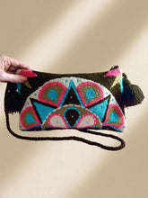 Load image into Gallery viewer, Handcrafted Wayuu terry cloth clutch with vibrant embellishments and tassels, adding artisanal elegance to any outfit.